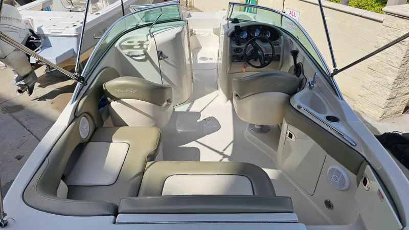 Slide: The Image of 2005 Sea Ray 220 Sundeck interior with seating, steering wheel, and dashboard. - 8