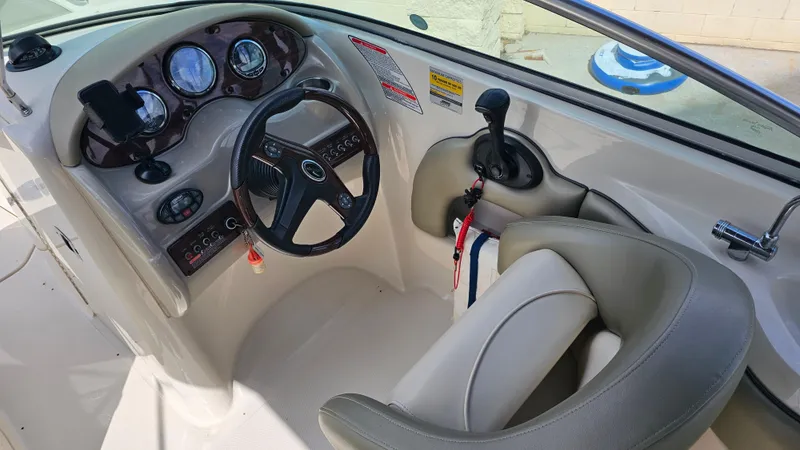 Slide: The Image of 2005 Sea Ray 220 Sundeck helm with steering wheel and control panel. - 9