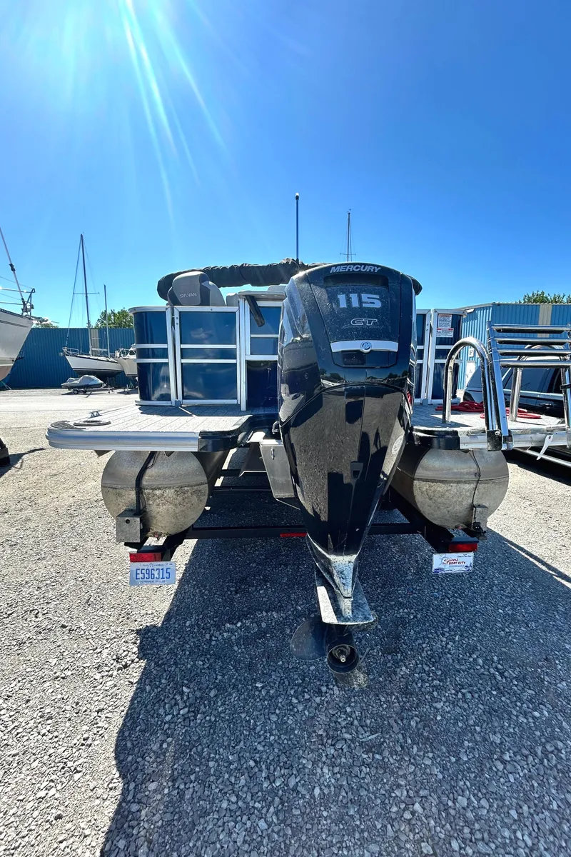 Slide: The Image of 2022 Sylvan L3 Party Fish pontoon boat with 115 HP motor in a marina. - 13