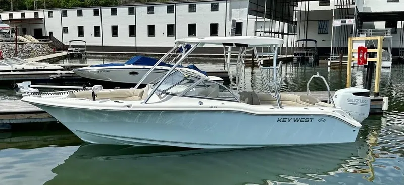The Image of 2023 Key West 239 DFS boat docked, featuring sleek design and Suzuki outboard motor. - 0