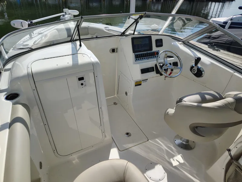 Slide: The Image of 2023 Key West 239 DFS boat interior with steering wheel and control panel. - 13