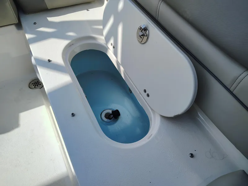 Slide: The Image of 2023 Key West 239 DFS boat storage compartment with open lid. - 16