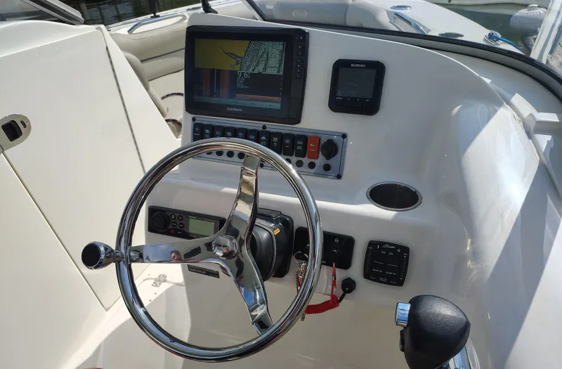 Slide: The Image of 2023 Key West 239 DFS boat dashboard with steering wheel and navigation system. - 18
