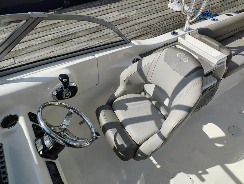 Slide: The Image of 2023 Key West 239 DFS boat interior with steering wheel and captain's chair. - 19