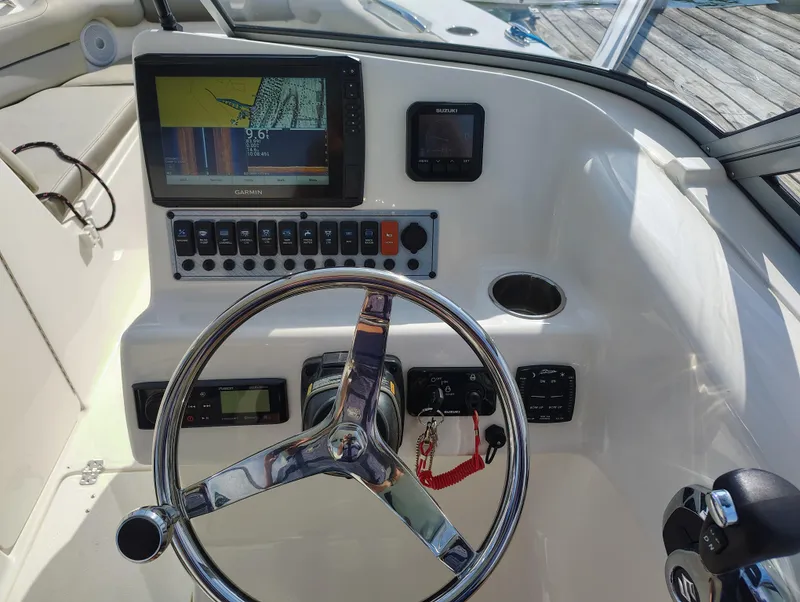 Slide: The Image of 2023 Key West 239 DFS boat dashboard with Garmin navigation system and steering wheel. - 21