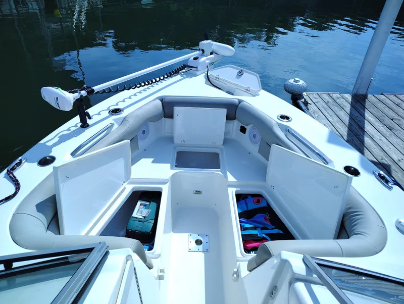 Slide: The Image of 2023 Key West 239 DFS boat interior with open storage compartments at dock. - 23