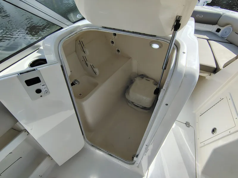 Slide: The Image of 2023 Key West 239 DFS boat storage compartment with open hatch, showcasing interior space. - 24