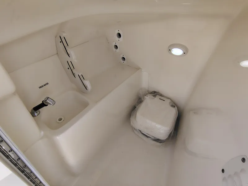 Slide: The Image of 2023 Key West 239 DFS boat interior with sink and storage area. - 25