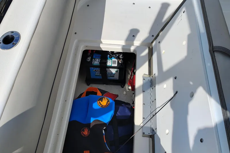 Slide: The Image of Storage compartment in 2023 Key West 239 DFS boat with battery and life jackets. - 28