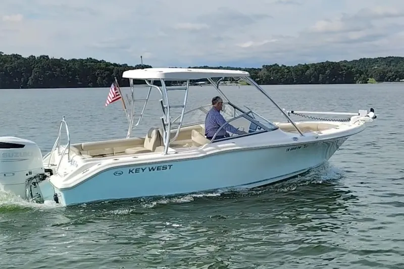 Slide: The Image of 2023 Key West 239 DFS boat cruising on a lake with an American flag. - 3