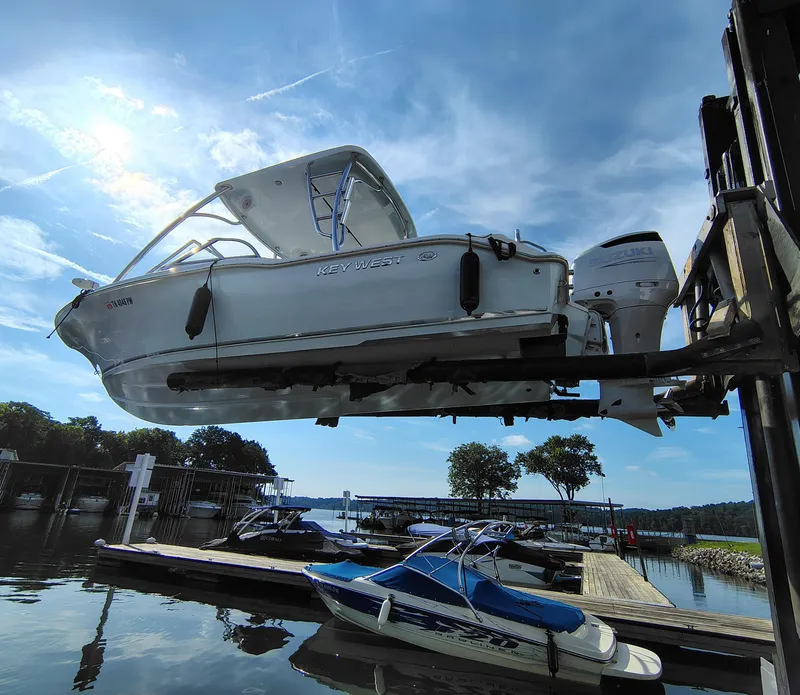 Slide: The Image of 2023 Key West 239 DFS boat lifted at marina, clear sky background. - 30