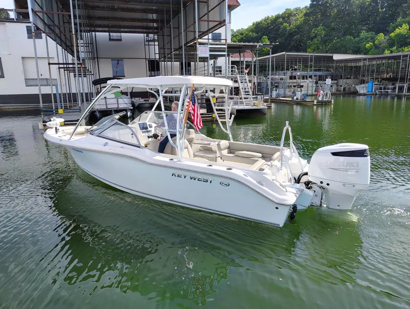 Slide: The Image of 2023 Key West 239 DFS boat on water near marina, featuring Suzuki outboard motor. - 5