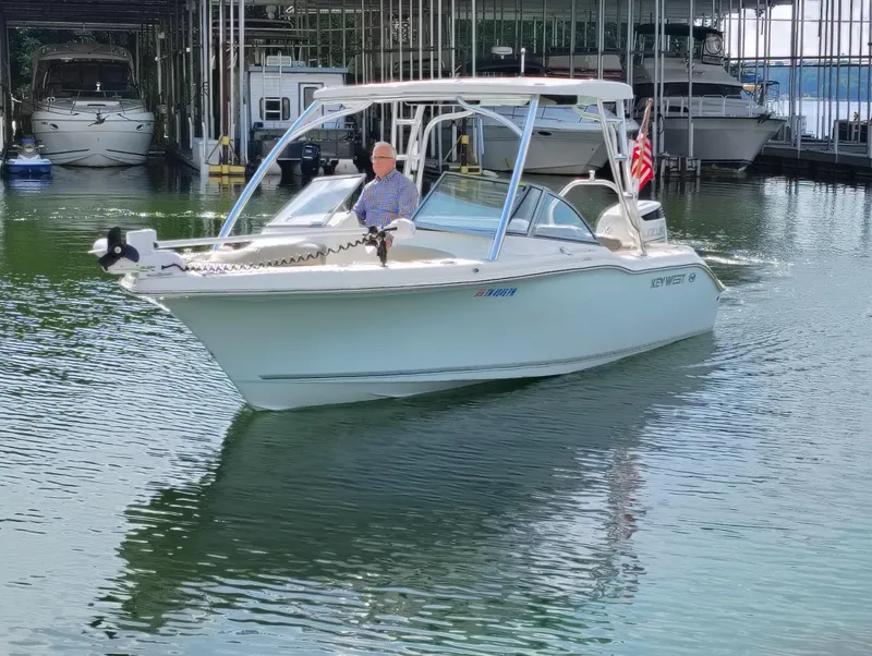 Slide: The Image of 2023 Key West 239 DFS boat on water, docked with American flag. - 8