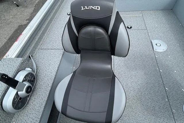 Slide: The Image of 2025 Lund 1875 Alaskan SS boat seat, gray and black design, on textured deck. - 12