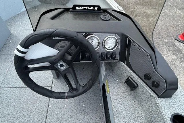 Slide: The Image of 2025 Lund 1875 Alaskan SS boat dashboard with steering wheel and gauges. - 6