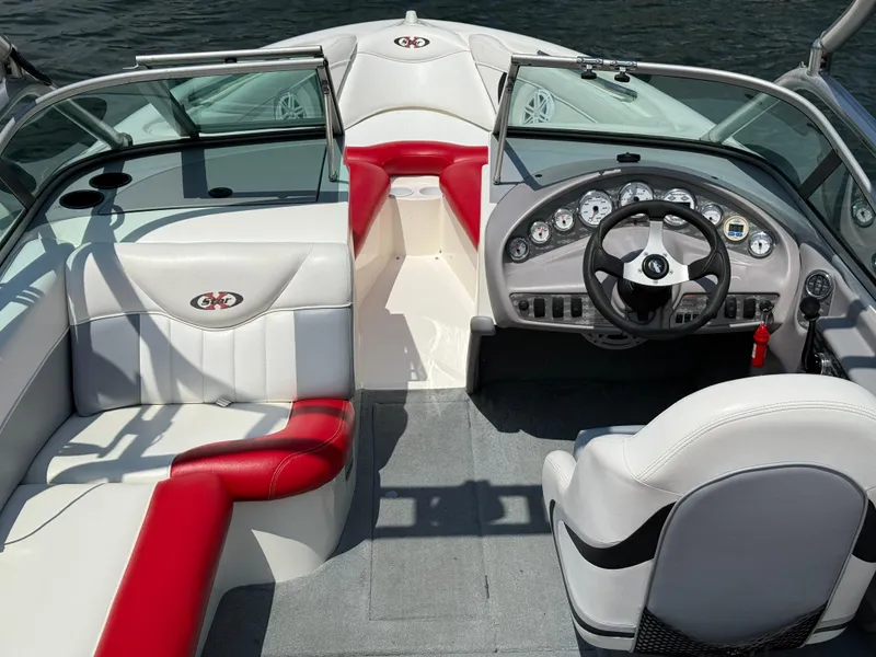 Slide: The Image of 2001 MasterCraft X-Star boat interior with red and white seating, steering wheel, and dashboard controls. - 11