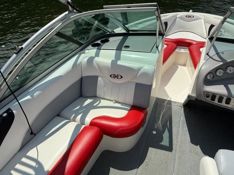 Slide: The Image of 2001 MasterCraft X-Star boat interior with red and white seating, on calm water. - 12