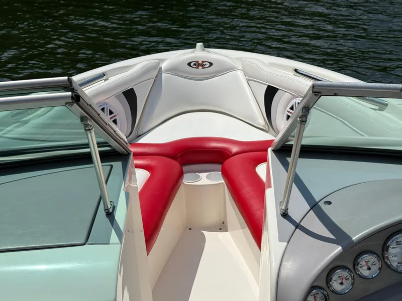 Slide: The Image of 2001 MasterCraft X-Star boat interior with red and white seating, on calm water. - 15