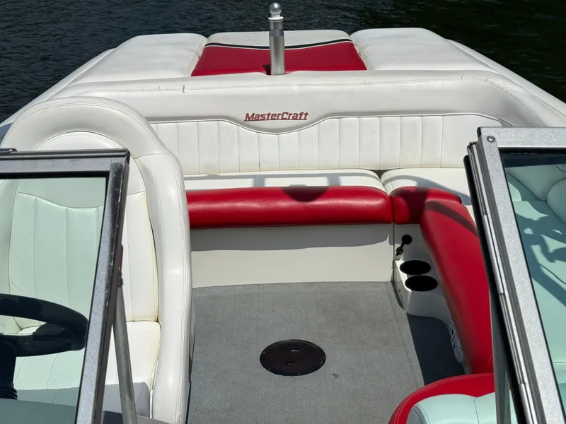 Slide: The Image of 2001 MasterCraft X-Star boat interior with red and white seating, on a sunny day. - 16