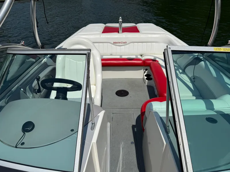 Slide: The Image of 2001 MasterCraft X-Star boat interior with red and white seating, open windshield, and steering wheel. - 17