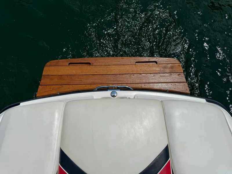 Slide: The Image of 2001 MasterCraft X-Star boat with wooden swim platform on water. - 9