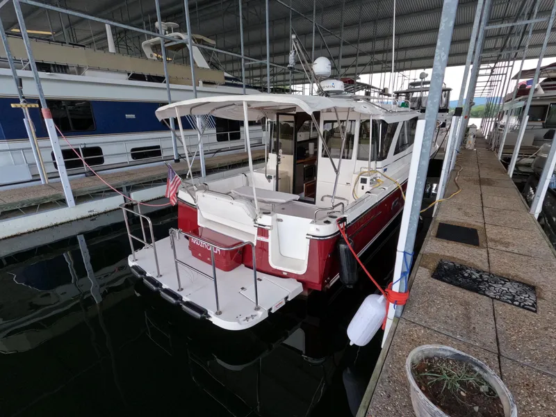 Slide: The Image of 2020 Cutwater C-30 Sedan docked in a covered marina, rear view. - 13
