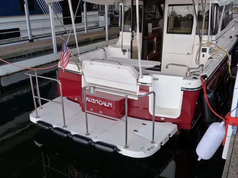 Slide: The Image of 2020 Cutwater C-30 Sedan docked, featuring a red and white exterior with an American flag. - 14