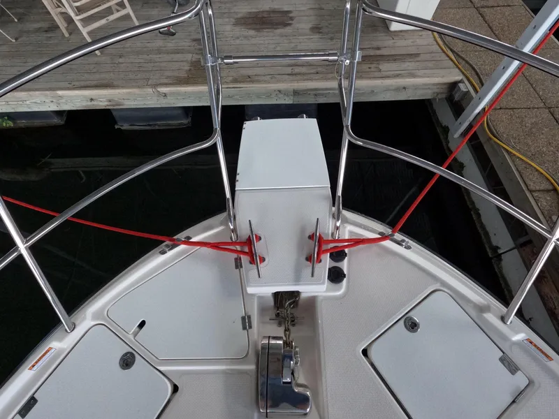 Slide: The Image of Bow of 2020 Cutwater C-30 Sedan with red dock lines and stainless steel railings. - 15