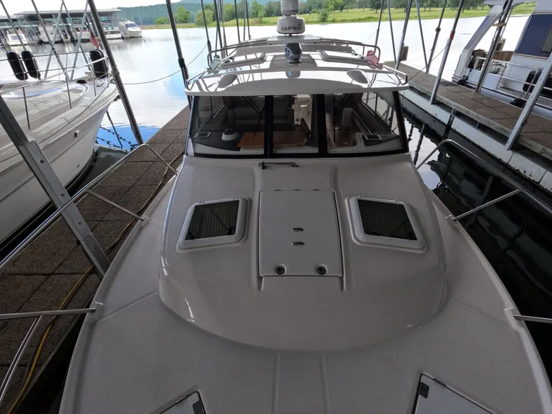 Slide: The Image of 2020 Cutwater C-30 Sedan docked, showcasing sleek design and spacious deck. - 17