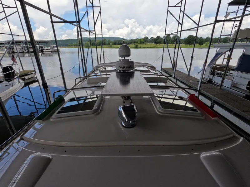 Slide: The Image of 2020 Cutwater C-30 Sedan boat docked, featuring Garmin equipment, under a cloudy sky. - 18