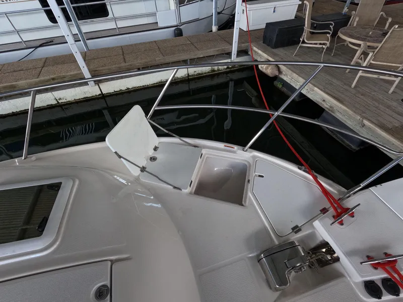 Slide: The Image of 2020 Cutwater C-30 Sedan boat deck with open hatch and dock view. - 19