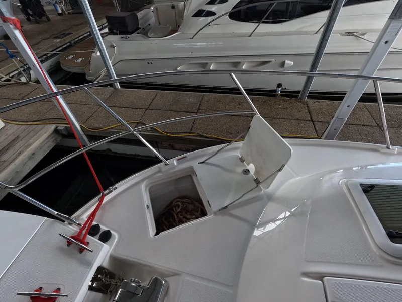 Slide: The Image of 2020 Cutwater C-30 Sedan boat deck with open storage compartment at dock. - 20