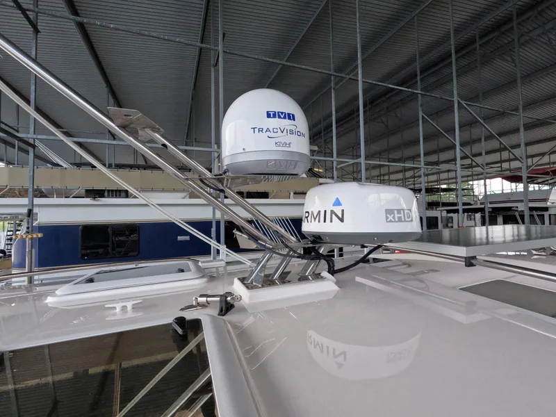 Slide: The Image of 2020 Cutwater C-30 Sedan with Garmin and TracVision equipment on the roof in a covered marina. - 21