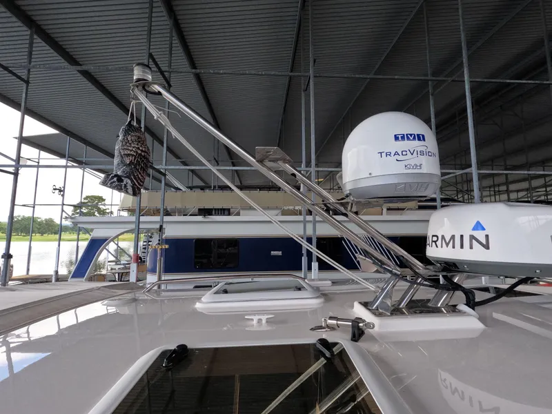 Slide: The Image of 2020 Cutwater C-30 Sedan boat with Garmin and TracVision equipment under a covered dock. - 22