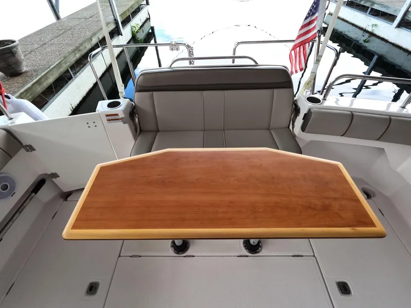 Slide: The Image of 2020 Cutwater C-30 Sedan boat interior with wooden table and seating area. - 24