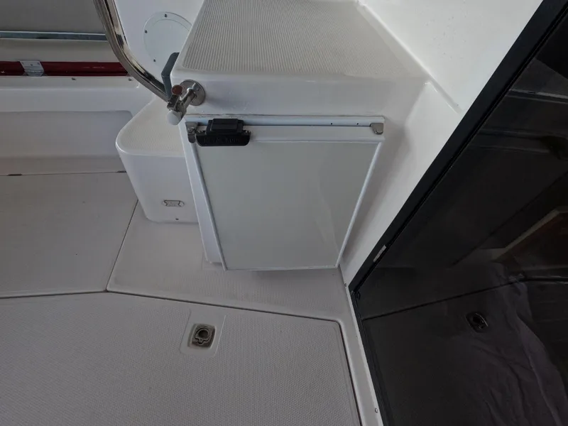 Slide: The Image of 2020 Cutwater C-30 Sedan interior with compact fridge and sleek design. - 28