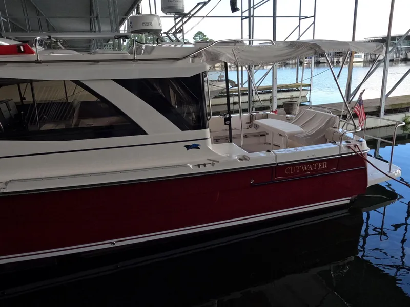 Slide: The Image of 2020 Cutwater C-30 Sedan boat docked in a marina, side view. - 3
