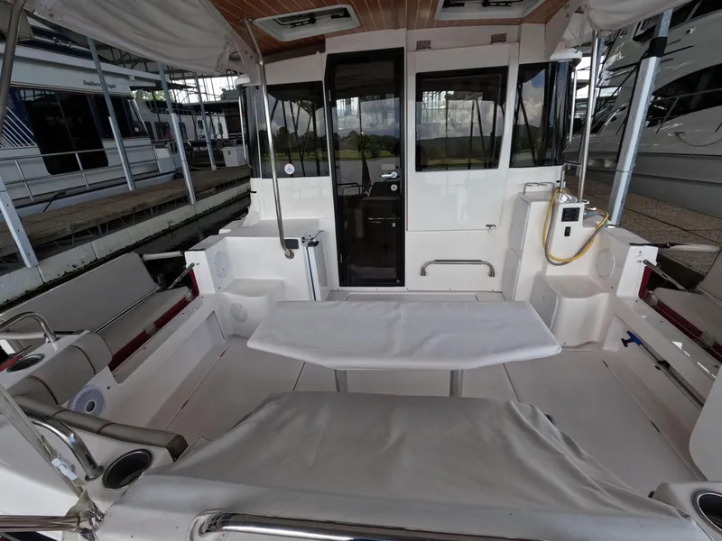 Slide: The Image of 2020 Cutwater C-30 Sedan boat interior with seating and table in a marina setting. - 31