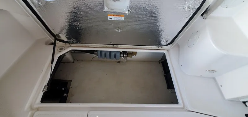 Slide: The Image of 2020 Cutwater C-30 Sedan storage compartment with insulated hatch and mechanical components. - 33