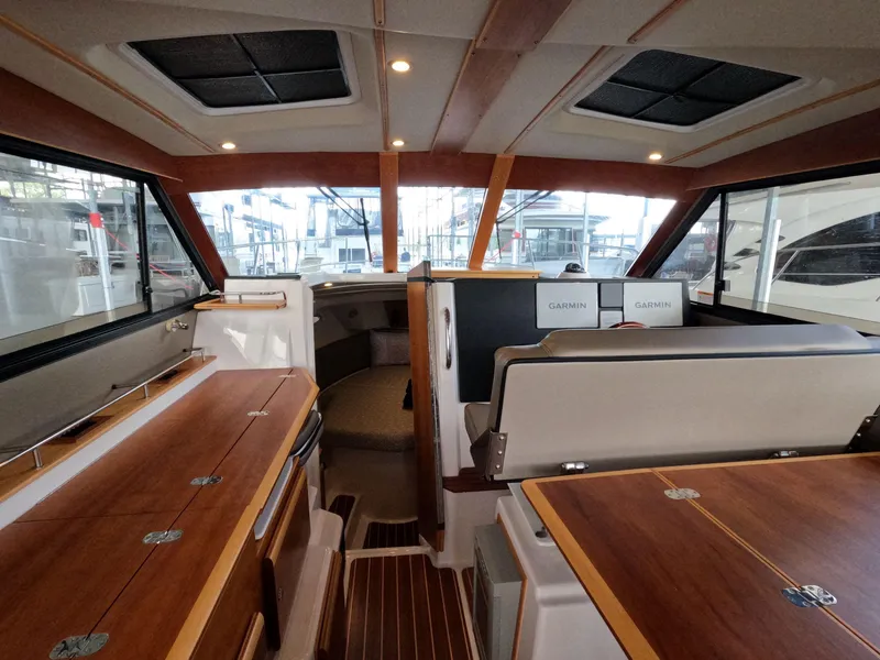 Slide: The Image of Interior of 2020 Cutwater C-30 Sedan boat with wood finish and Garmin electronics. - 36