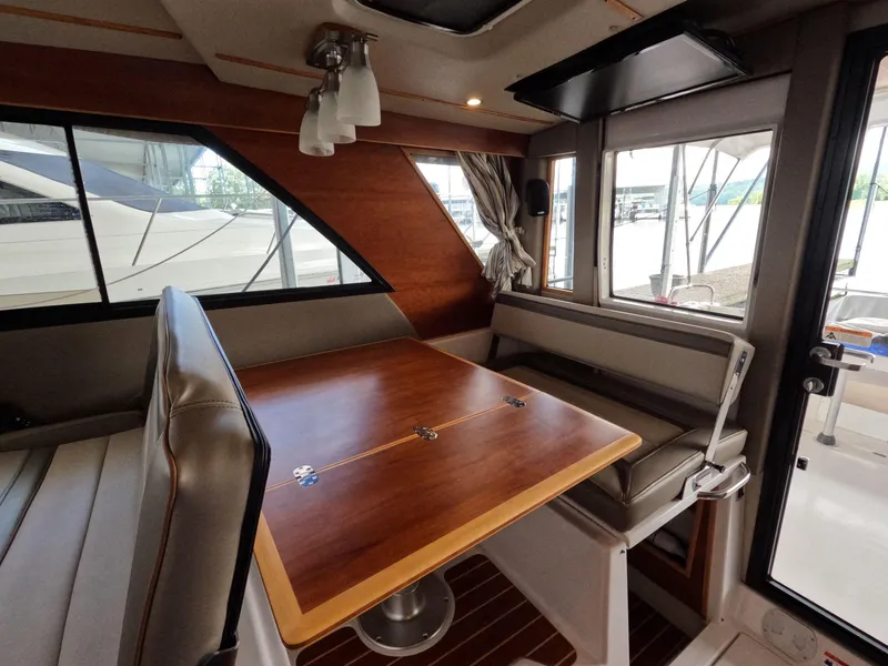 Slide: The Image of Interior of 2020 Cutwater C-30 Sedan with wooden table and seating area. - 39