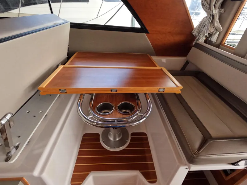 Slide: The Image of Interior of 2020 Cutwater C-30 Sedan with wooden table and cushioned seating. - 40