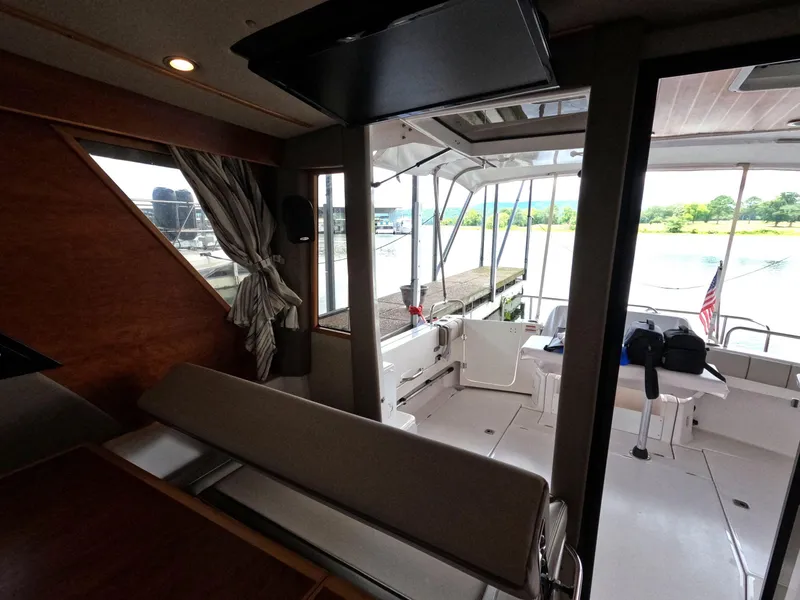 Slide: The Image of Interior view of 2020 Cutwater C-30 Sedan boat, featuring seating and dockside view. - 43