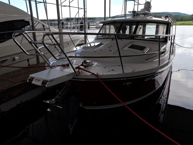 Slide: The Image of 2020 Cutwater C-30 Sedan boat docked in a marina, front view. - 6