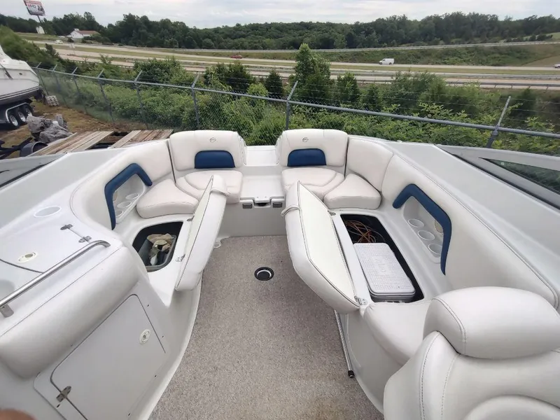 Slide: The Image of 2005 Crownline 270 BR boat interior with white seating and storage compartments. - 18