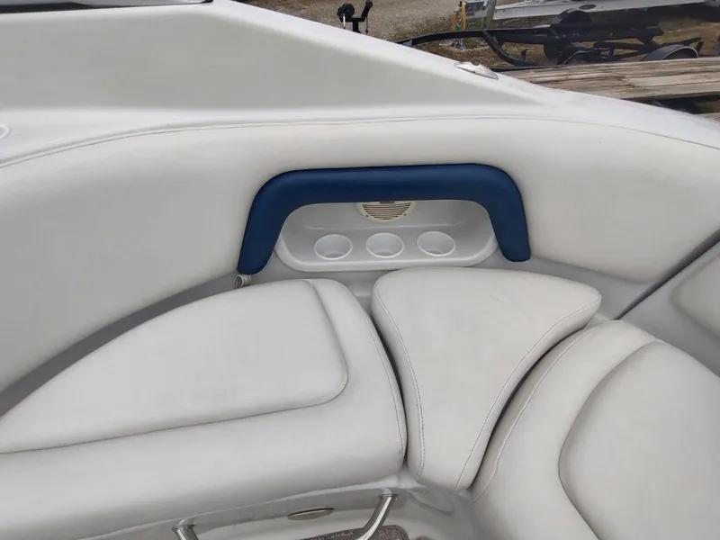 Slide: The Image of 2005 Crownline 270 BR boat interior with white cushioned seating and cup holders. - 19