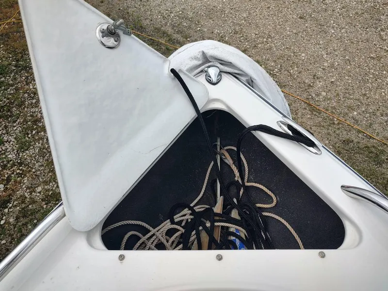 Slide: The Image of Open storage compartment on 2005 Crownline 270 BR boat with ropes inside. - 23