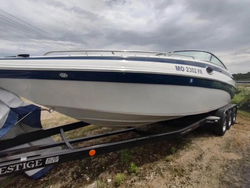 Slide: The Image of 2005 Crownline 270 BR boat on trailer, cloudy sky background. - 28