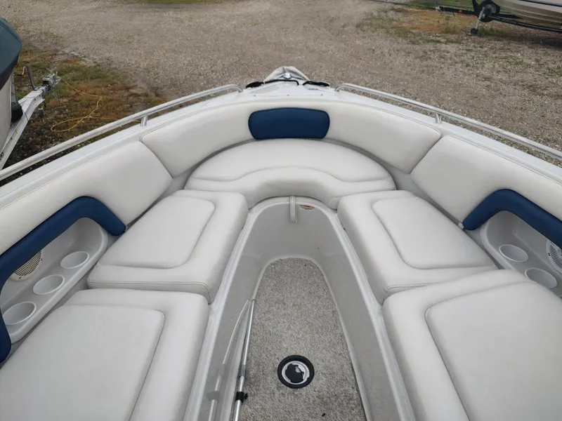 Slide: The Image of 2005 Crownline 270 BR boat interior with white and blue cushioned seating. - 29