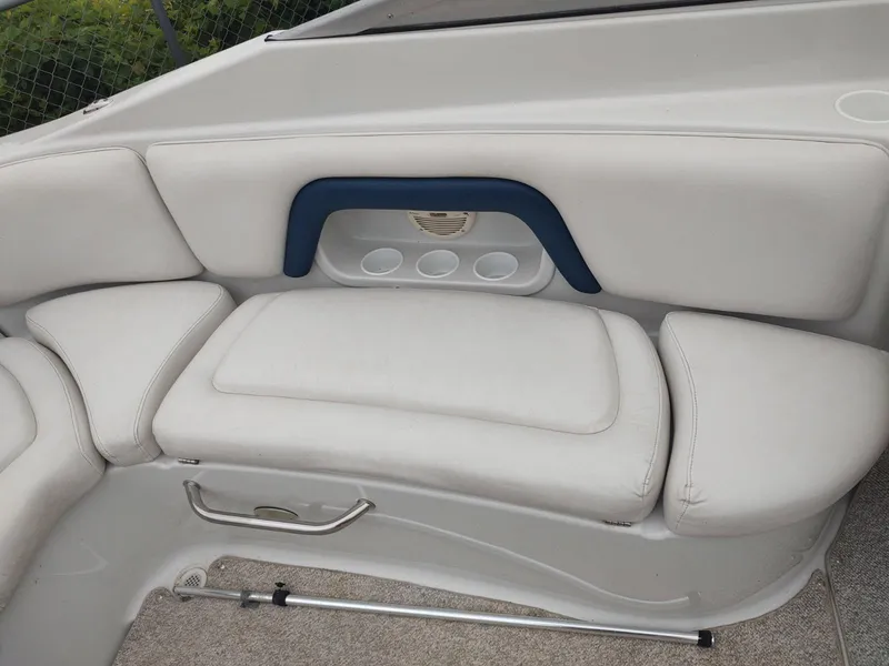 Slide: The Image of 2005 Crownline 270 BR boat interior with white cushioned seating and blue accent. - 3